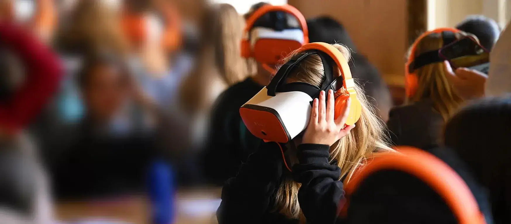 Students using virtual reality headsets in a classroom setting for immersive learning experiences.
