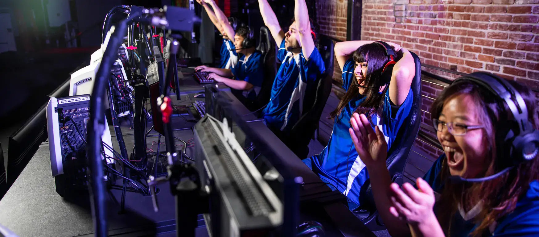 Excited esports players celebrating a win, highlighting teamwork and enthusiasm in gaming culture.