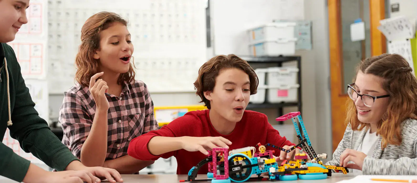 Students joyfully engaging with LEGO Education SPIKE Prime activities in a classroom setting.
