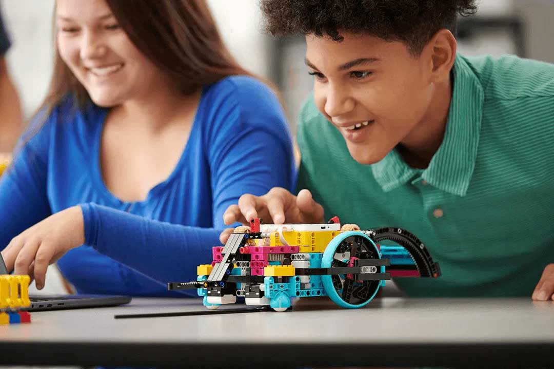 A student engaged with a colorful LEGO® Education secondary project, showcasing hands-on learning in the classroom.