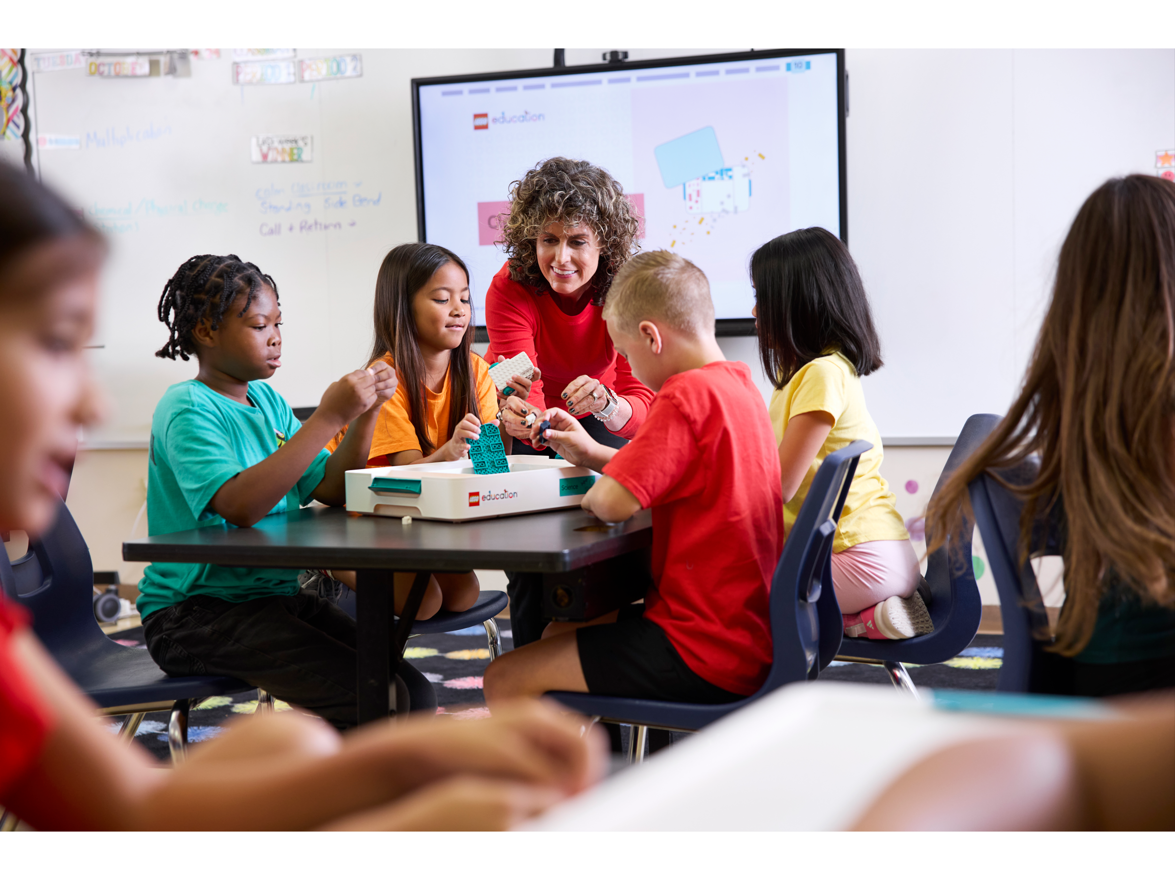 Two students engaged in a hands-on LEGO Education Science project, building and experimenting with robotics.
