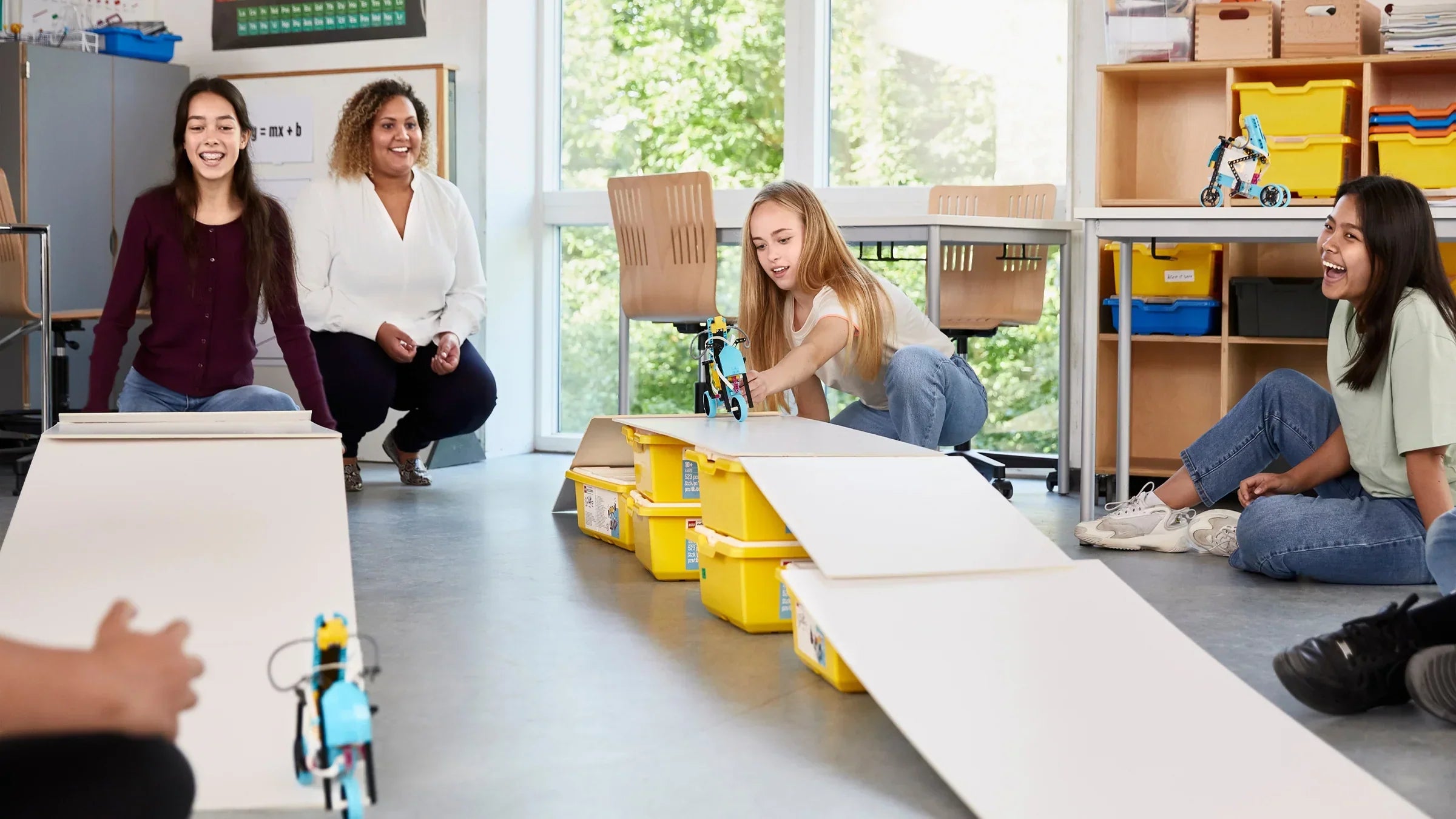 Students engaging with LEGO Education in a classroom while experimenting with robotic projects.