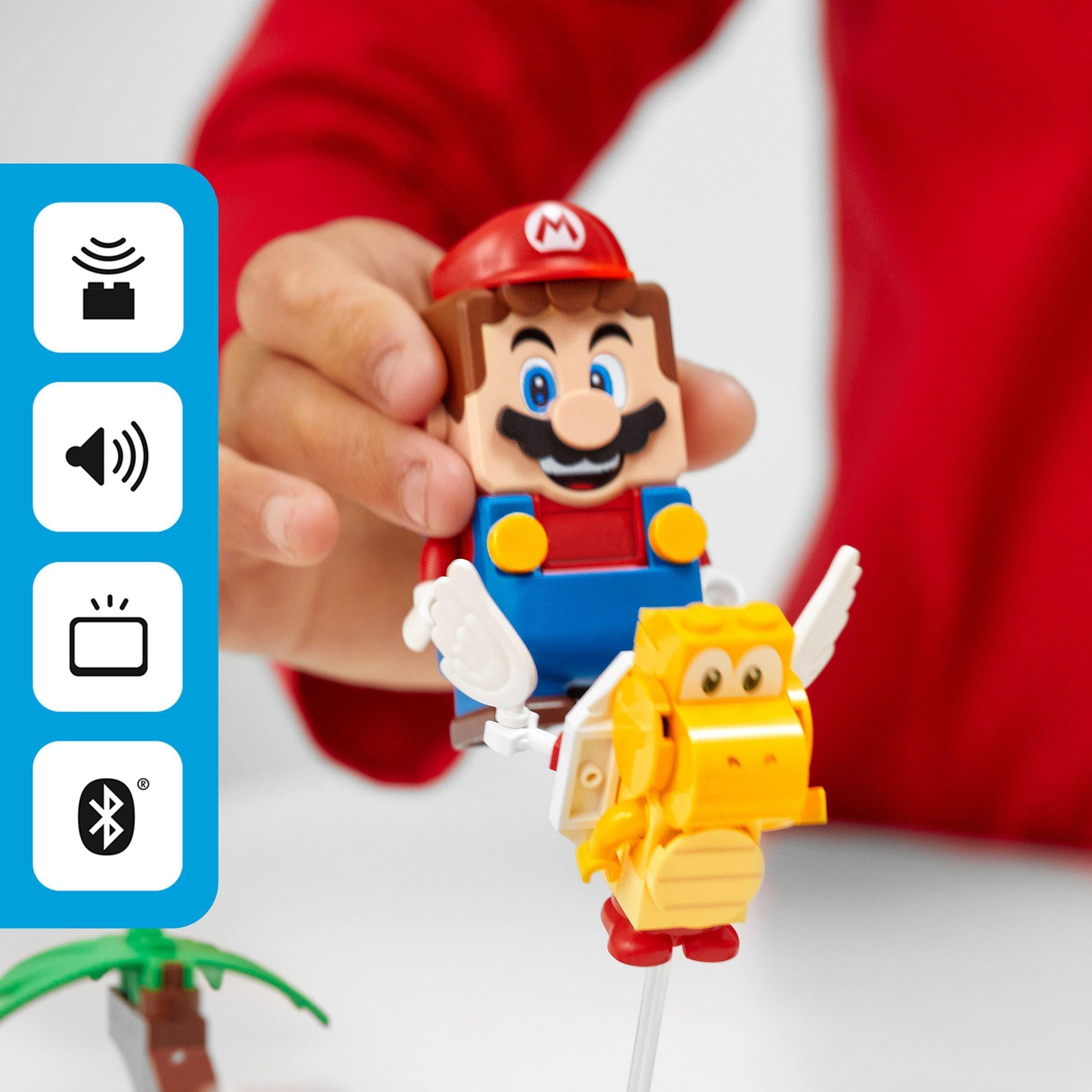 Child interacting with LEGO® Mario, featuring a yellow character, in the Poison Swamp Expansion Set 71383.
