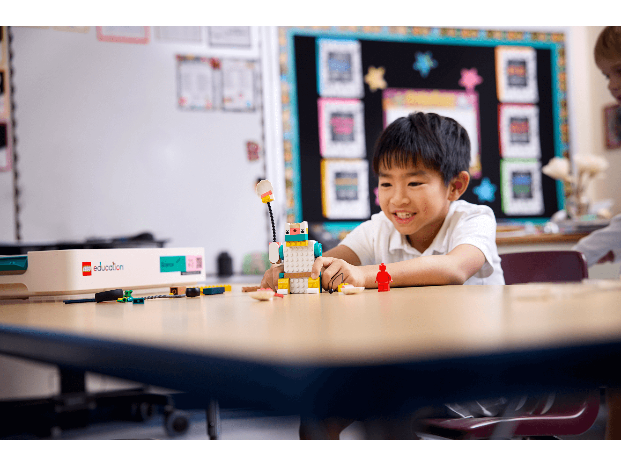Young student engaged with LEGO® Education Science kit, building creatively in a classroom setting.