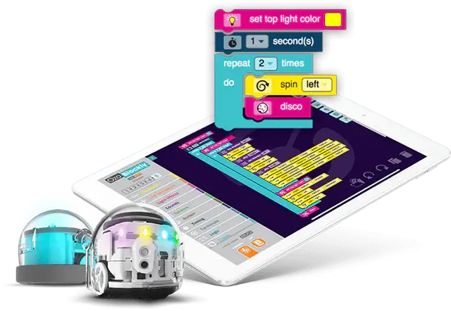 Colorful coding commands on a tablet next to two programmable robots, showcasing interactive learning in robotics.