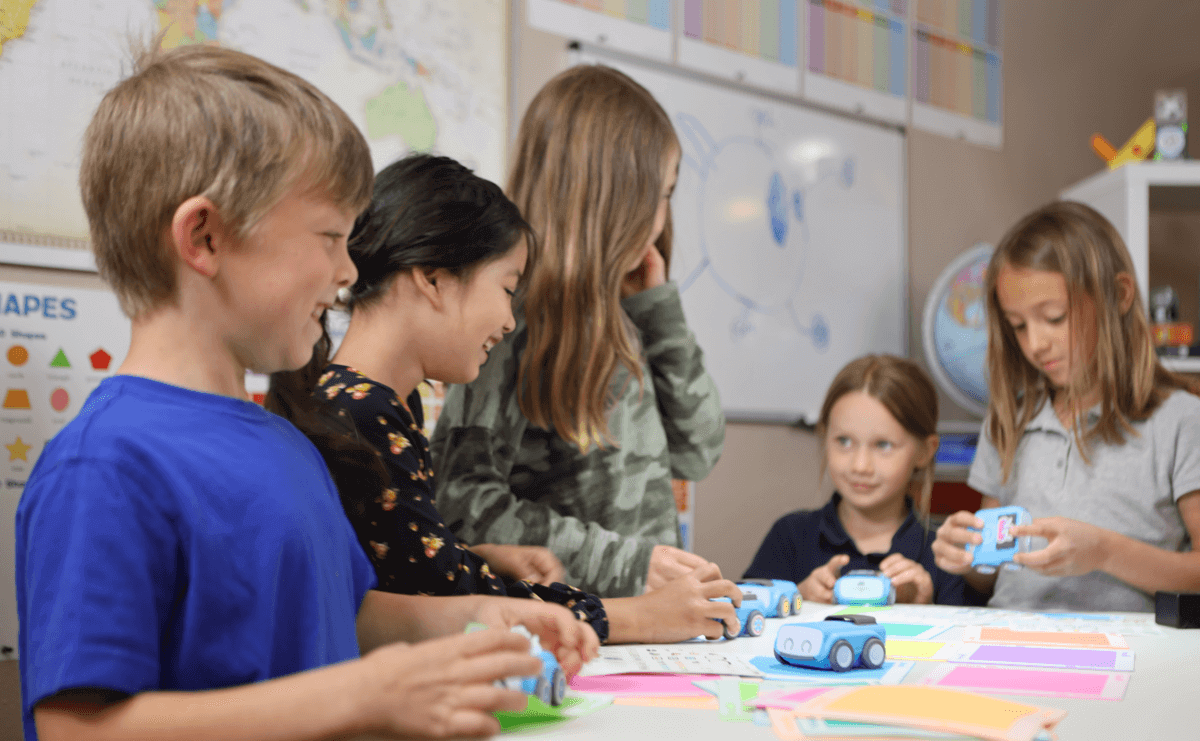 Kids engaged in learning with Sphero indi™, designing creative mazes and enhancing STEAM skills.