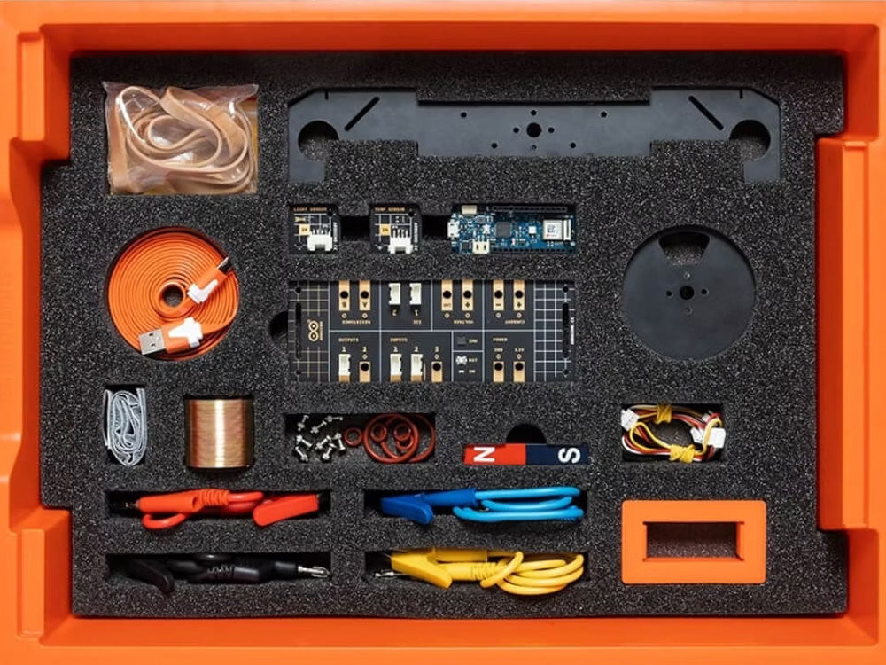 Multicolor electronics kit in an orange box, featuring wires, connectors, and components organized in foam inserts.