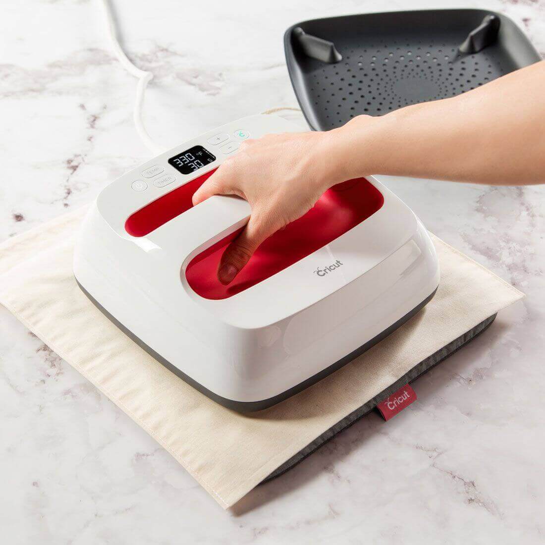 Cricut EasyPress 2 in Raspberry color, showcasing heat settings for professional iron-on projects.