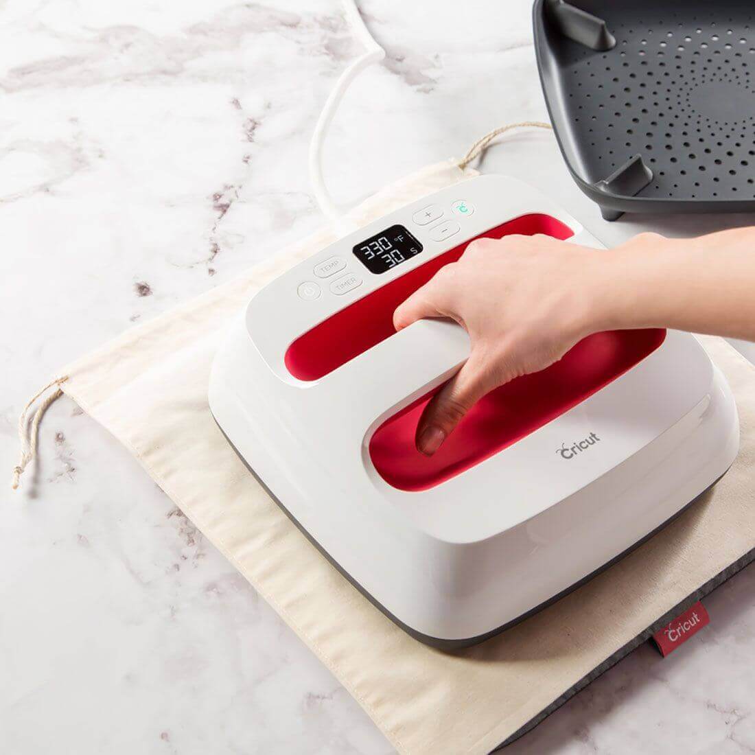 Cricut EasyPress Mat (12x12") with EasyPress™ tool for flawless iron-on transfers on a work surface.