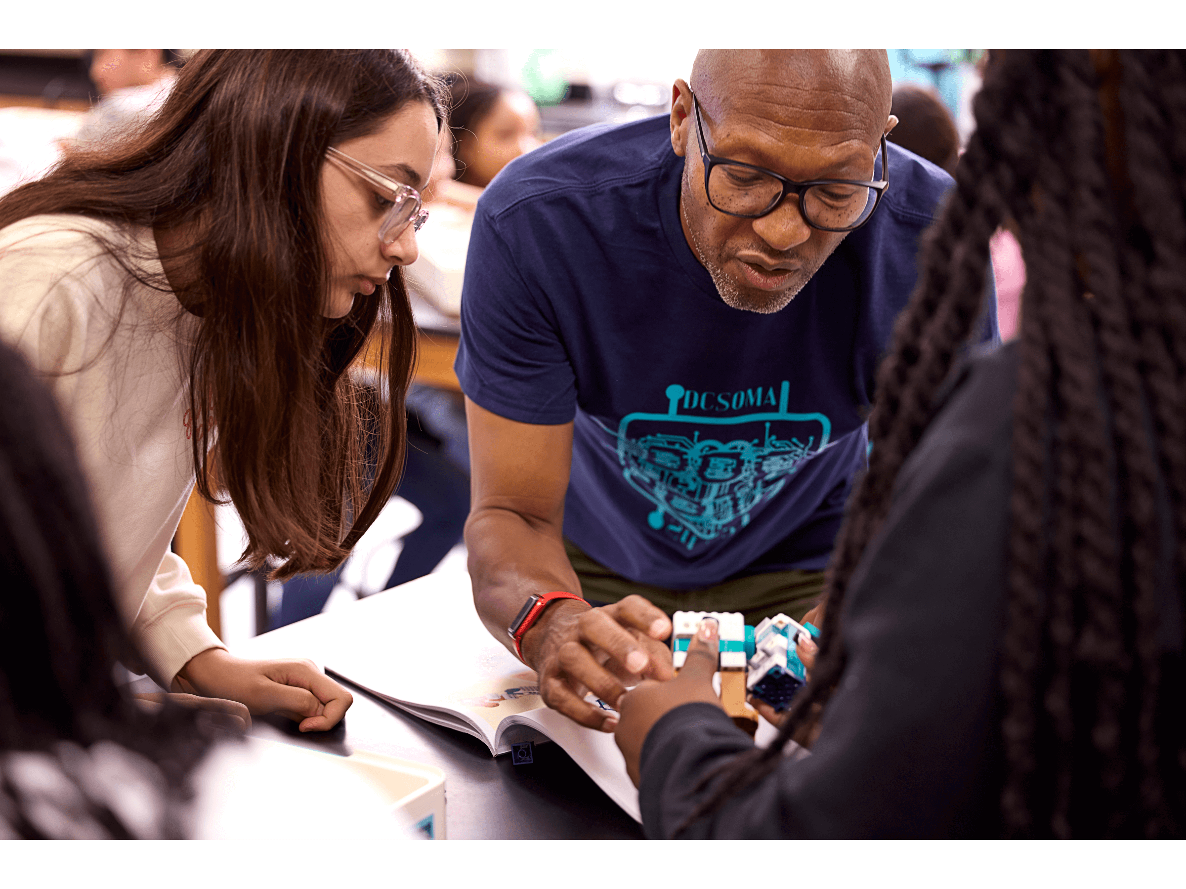 Students and teacher collaborating on a LEGO® Education Science project in a classroom setting.