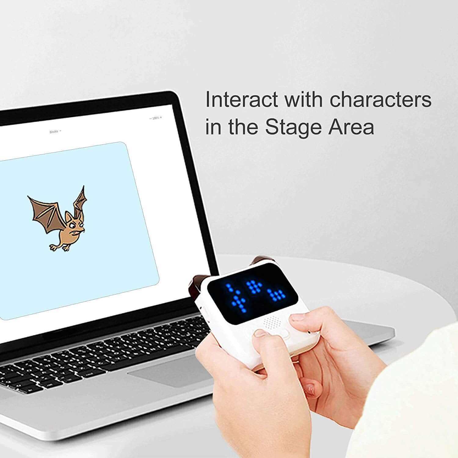Child interacting with characters using Makeblock Codey Rocky coding robot and laptop interface.