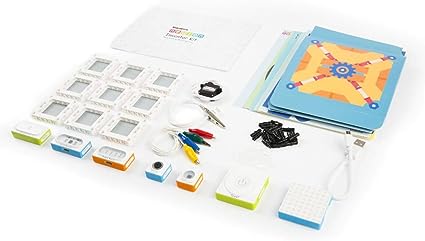 Makeblock Neuron Artist Kit displaying electronic blocks, sensors, cardboard templates, and accessories for creative learning.