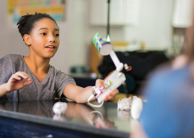 Student engaging with LittleBits STEAM kit, showcasing creativity and hands-on learning in a classroom setting.