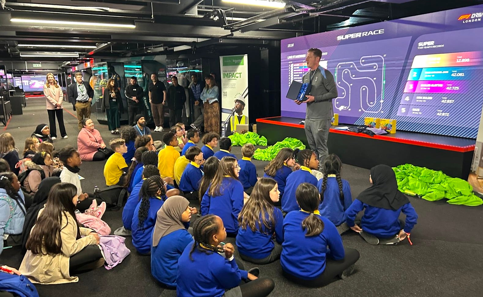 Students engaged in a hands-on STEM workshop with Schneider Electric, learning about technology and teamwork.