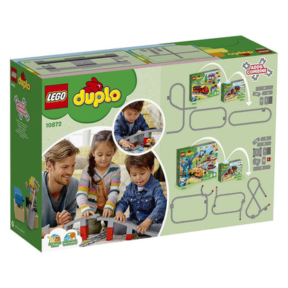 LEGO® DUPLO Town Train Bridge and Tracks Set 10872 box featuring children playing with train tracks and bridge components.