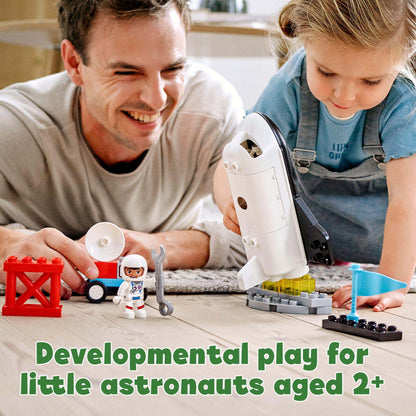 A father and daughter engaged in developmental play with LEGO® DUPLO Space Shuttle set for toddlers aged 2 and up.