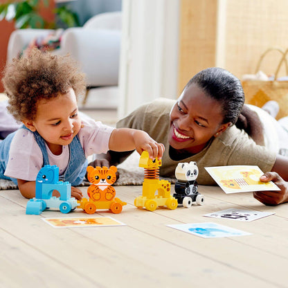 A child and parent enjoying playtime with LEGO® DUPLO Animal Train Toy, exploring colorful animal figures.