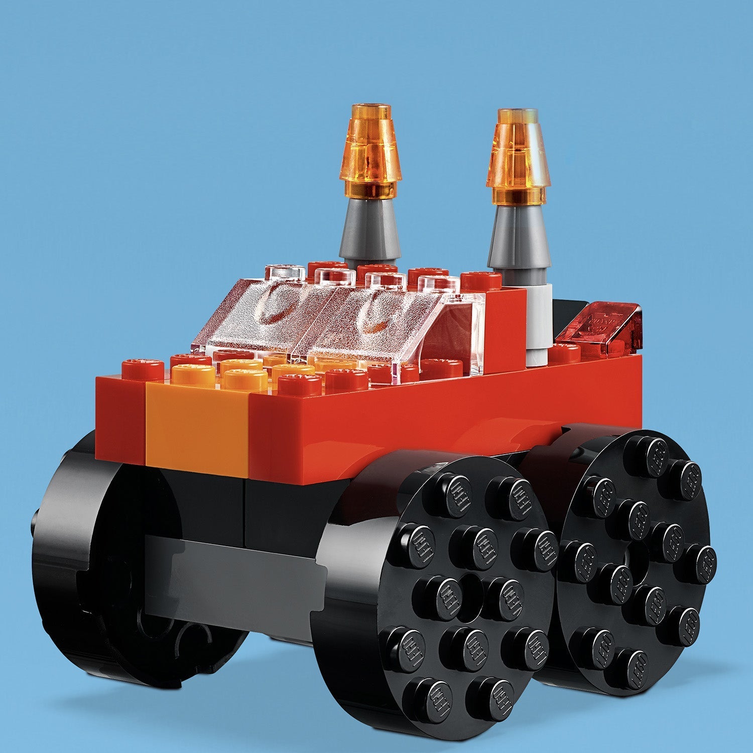 Colorful LEGO® Classic building toy vehicle with orange and black bricks and transparent elements, perfect for creative play.