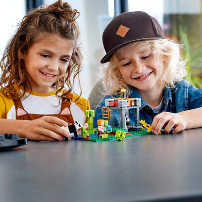 Two children playing with LEGO® Minecraft The Panda Nursery set, featuring cute pandas and colorful blocks.