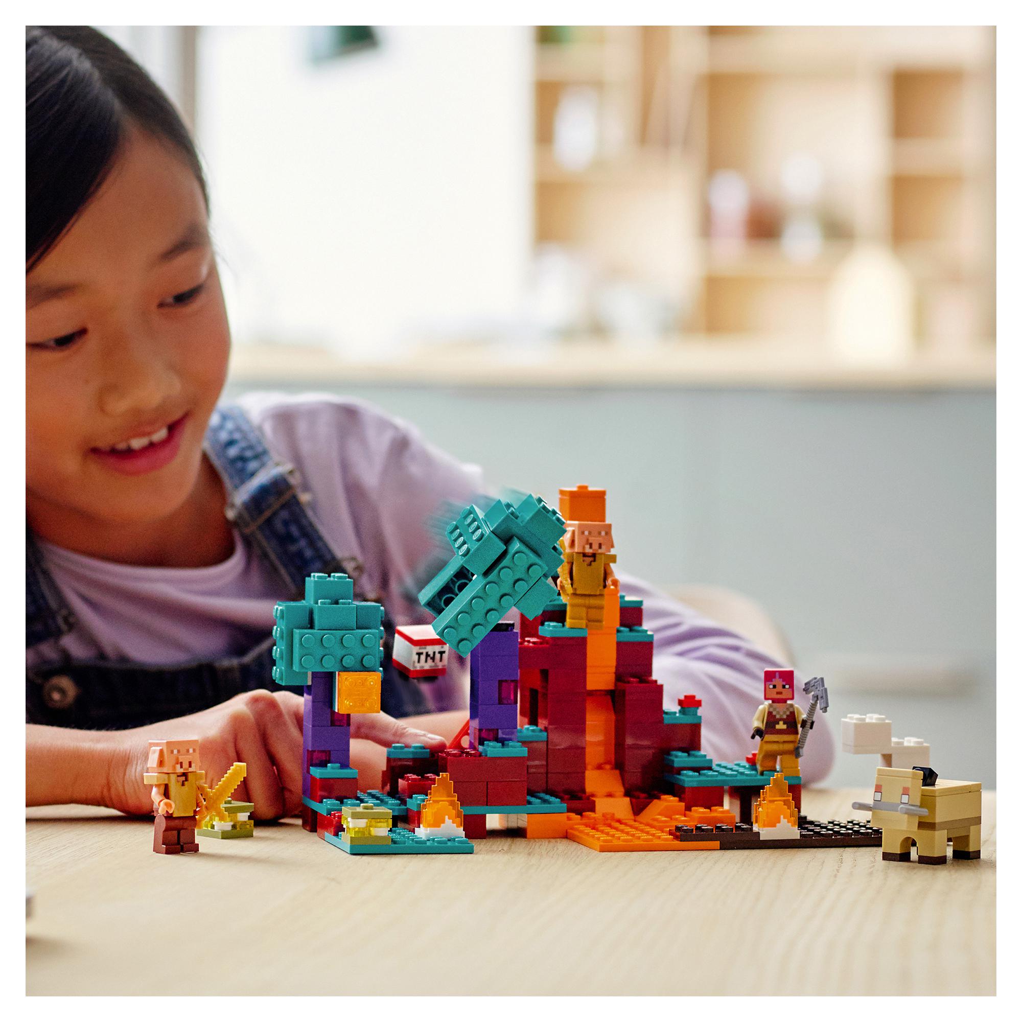 Child playing with LEGO® Minecraft The Warped Forest building toy, featuring playful adventures and characters.