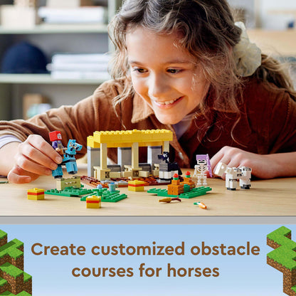 Child playing with LEGO® Minecraft The Horse Stable set, building obstacle courses for horses.