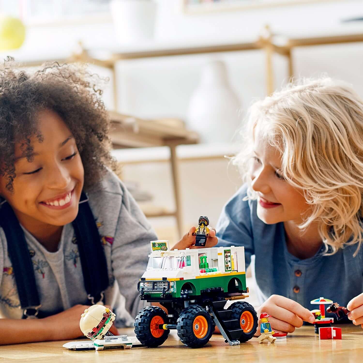 Two kids playing with the LEGO® Creator 3in1 Monster Burger Truck set, enjoying creativity and fun.