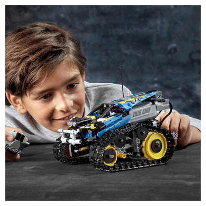 Child playing with LEGO Technic Stunt Racer RC Car Toy 42095, showcasing its remote control features and design.