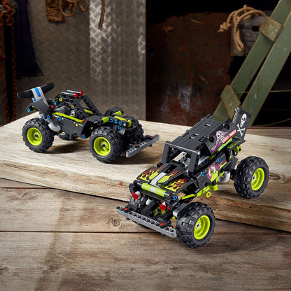 LEGO Technic Monster Jam Grave Digger toy 42118 and off-road buggy models displayed on wooden surface.