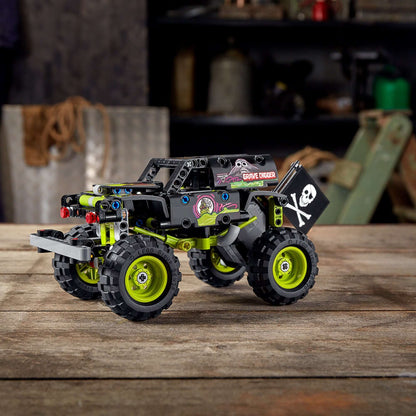 LEGO Technic Monster Jam Grave Digger truck model 42118 in a workshop setting with off-road buggy design.
