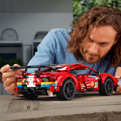 LEGO Technic Ferrari 488 GTE model being assembled by an enthusiast, showcasing detailed craftsmanship and design.