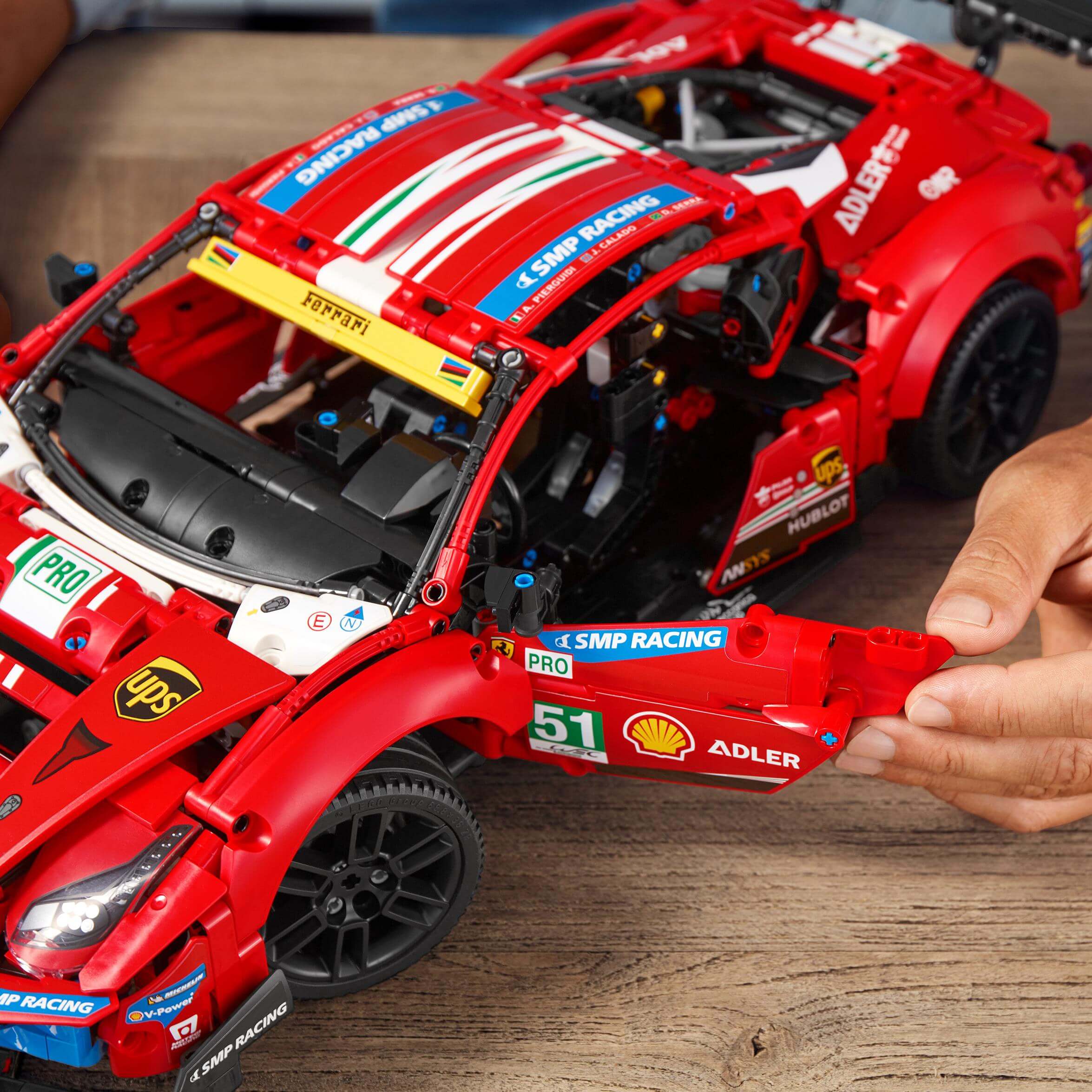 Detailed LEGO® Technic Ferrari 488 GTE model with open doors, showcasing intricate build and design.