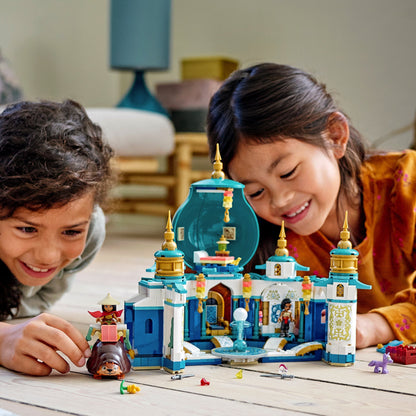 Two children playing with the LEGO® Disney Raya and the Heart Palace set, featuring minidoll figures and colorful palace design.