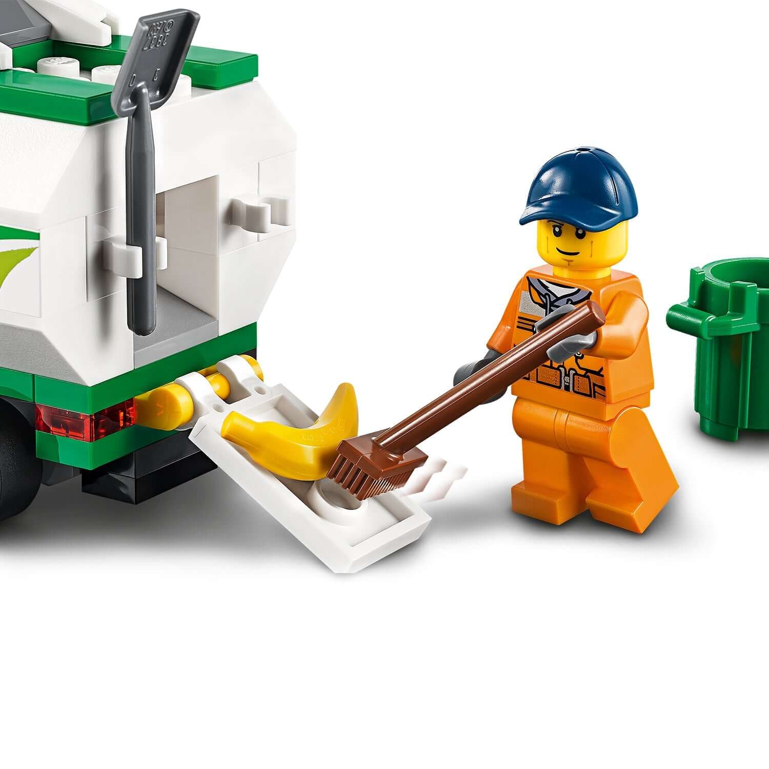 LEGO® City Street Sweeper 60249 with minifigure cleaning up, featuring spinning brushes and a trash bin.
