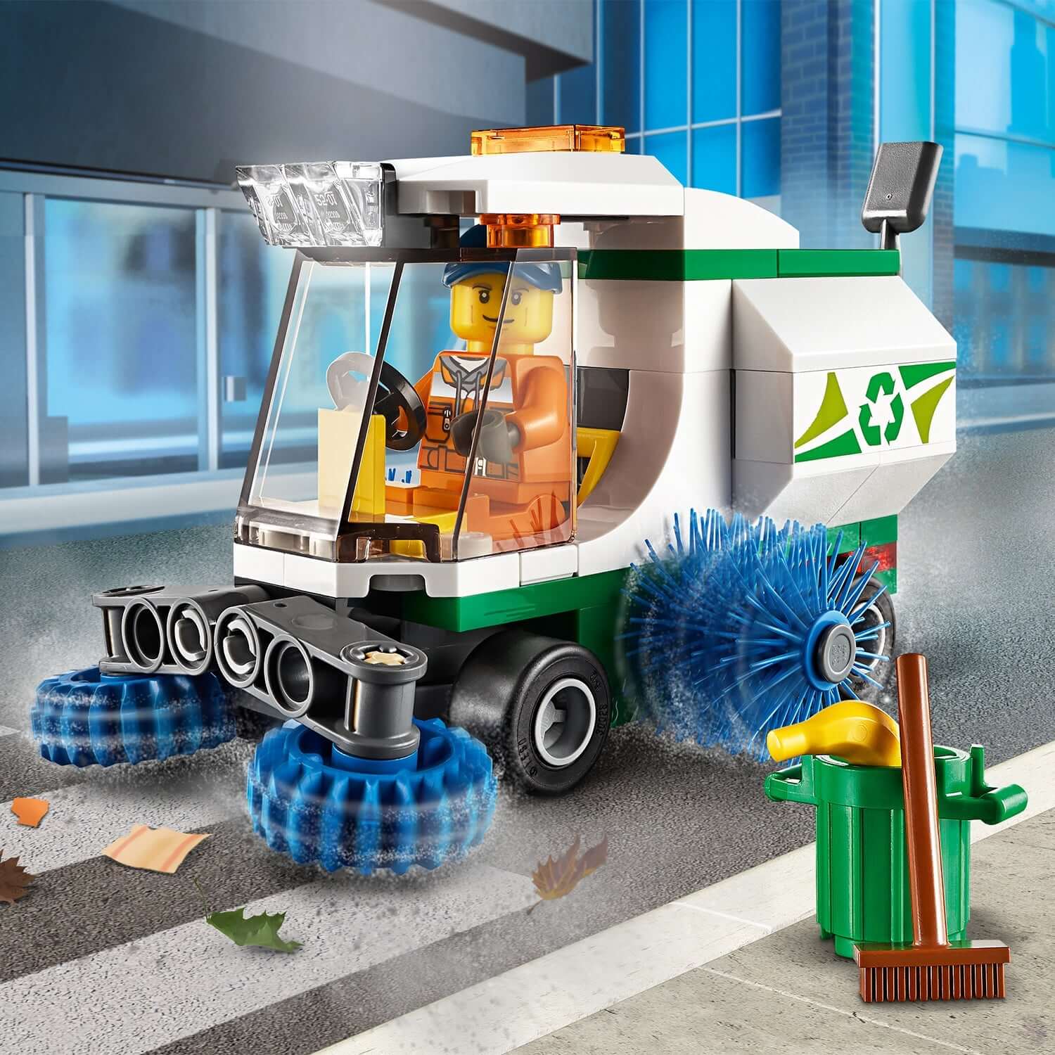 LEGO® City Great Vehicles Street Sweeper Toy 60249 with driver minifigure and spinning brushes on a city street.