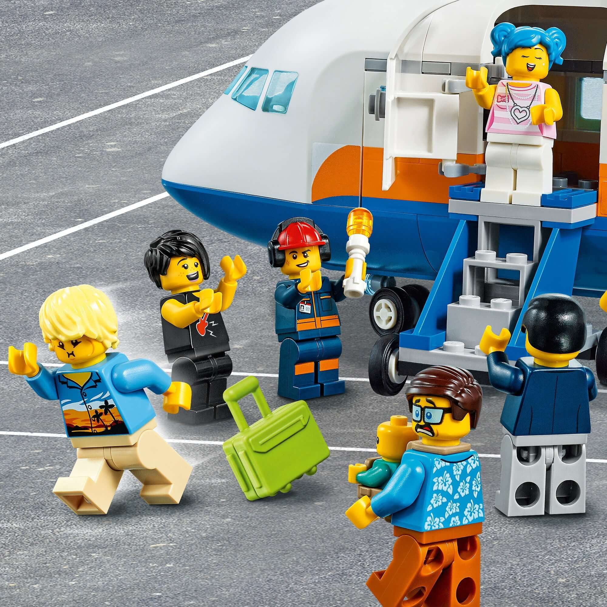 LEGO® City Passenger Airplane set with mini-figures boarding, including a family and a pilot by the plane steps.