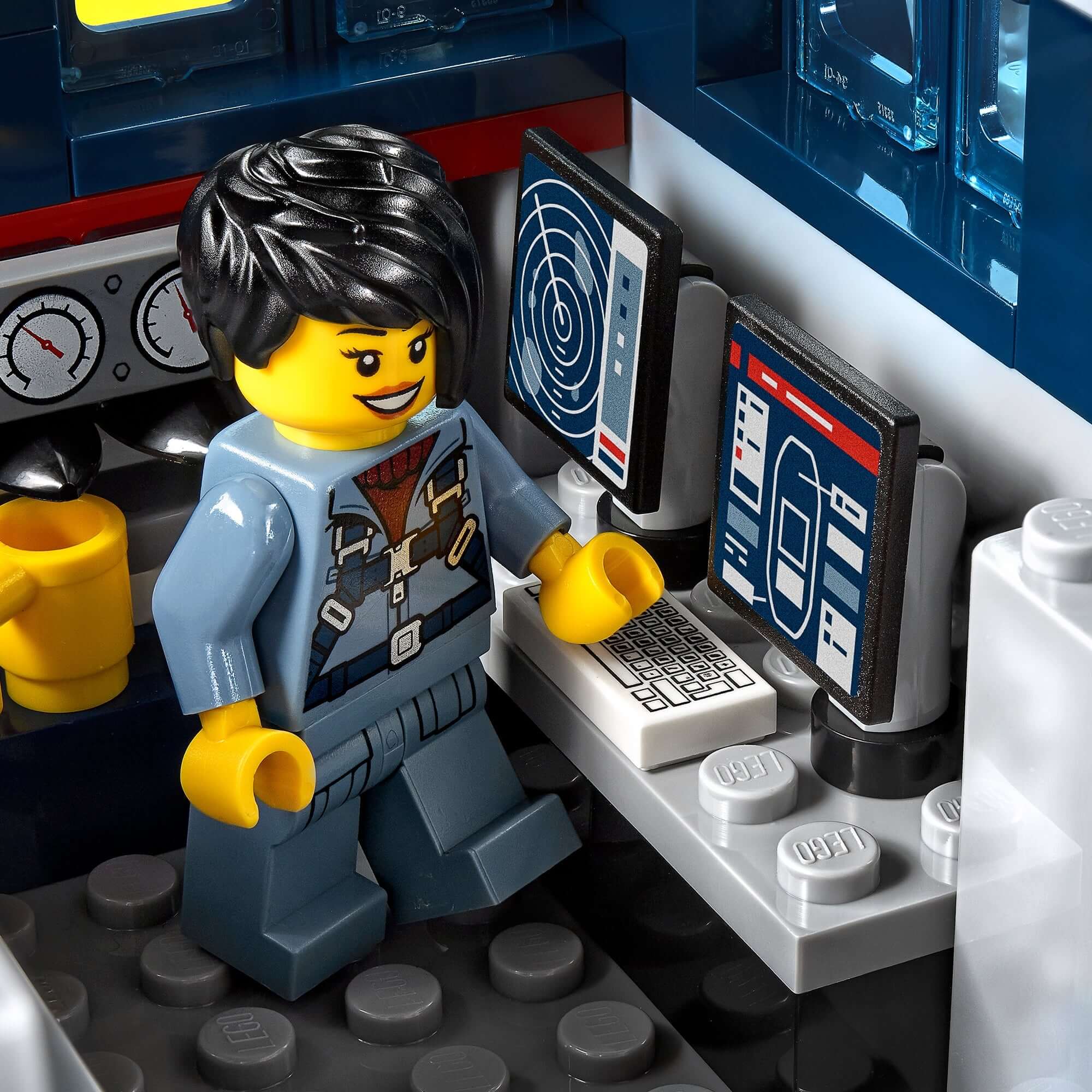 LEGO City Ocean Exploration Ship playset featuring a minifigure using computer equipment in the ship's control room.