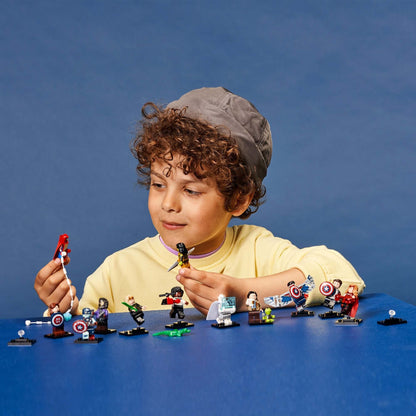Child exploring LEGO® Marvel Minifigures 71031 set with various characters and accessories on a blue background.