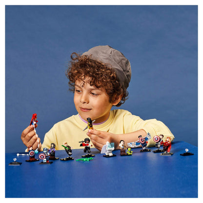 Child exploring LEGO® Minifigures Marvel Studios set 71031, showcasing mini superheroes and accessories.