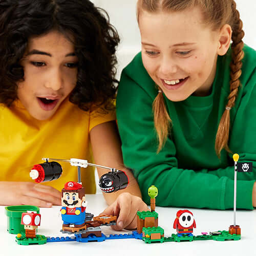 Kids enjoying the LEGO® Super Mario™ Boomer Bill Barrage Expansion Set with Mario character and fun game elements.