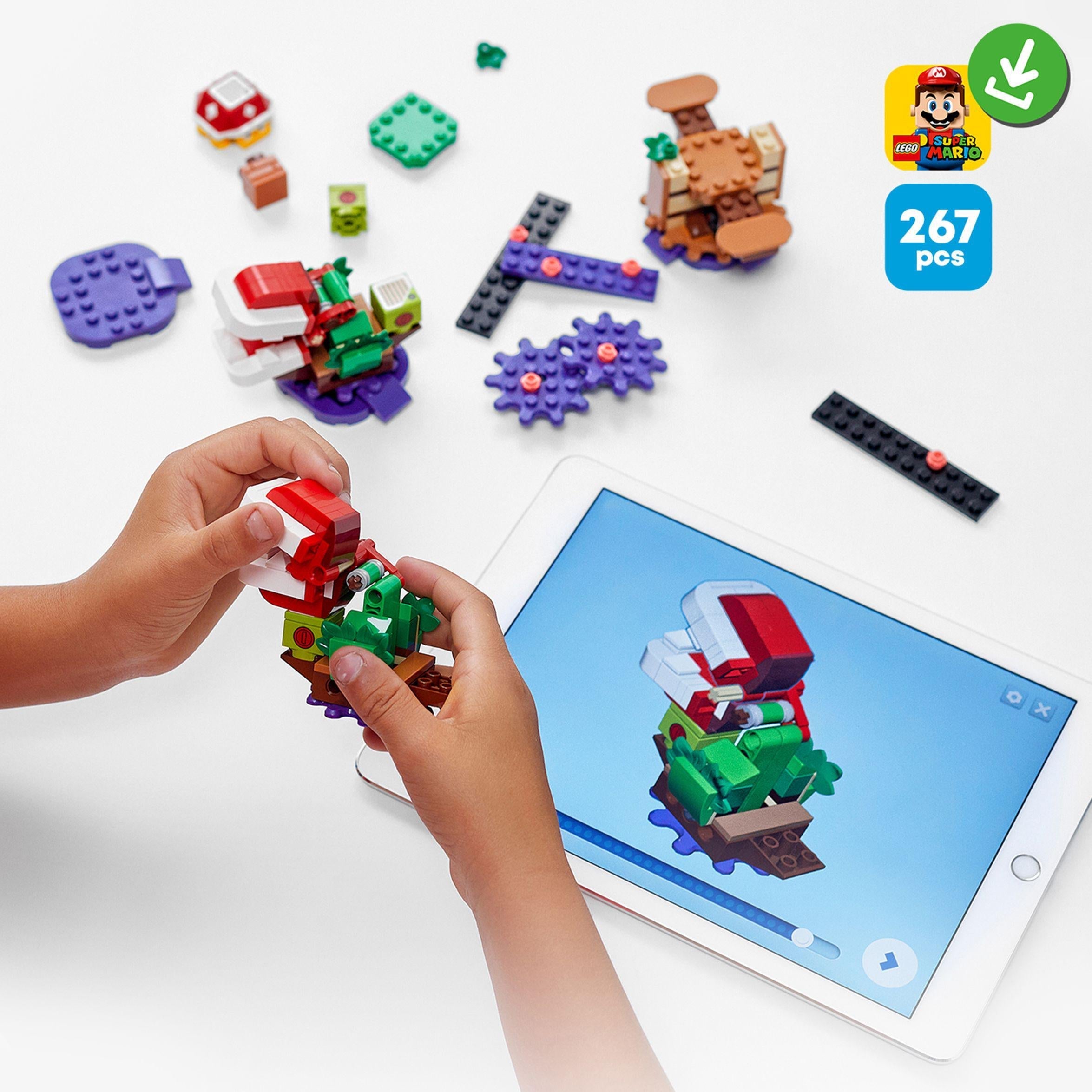 Child building with LEGO® Super Mario Piranha Plant Expansion Set 71382, featuring interactive instructions on tablet.