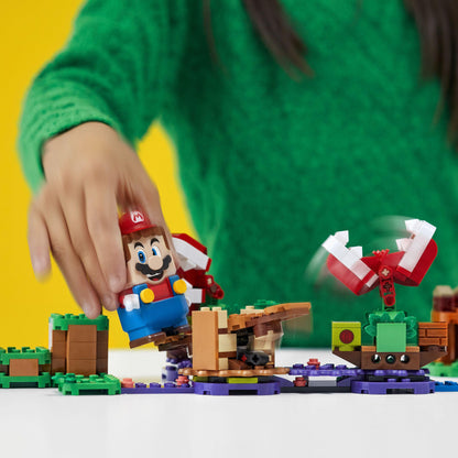 Child playing with LEGO® Super Mario Piranha Plant Expansion Set 71382, featuring Mario and Piranha Plants.