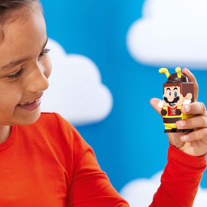 Child holding LEGO® Super Mario Bee Mario figure with a happy expression, perfect for interactive play and fun.