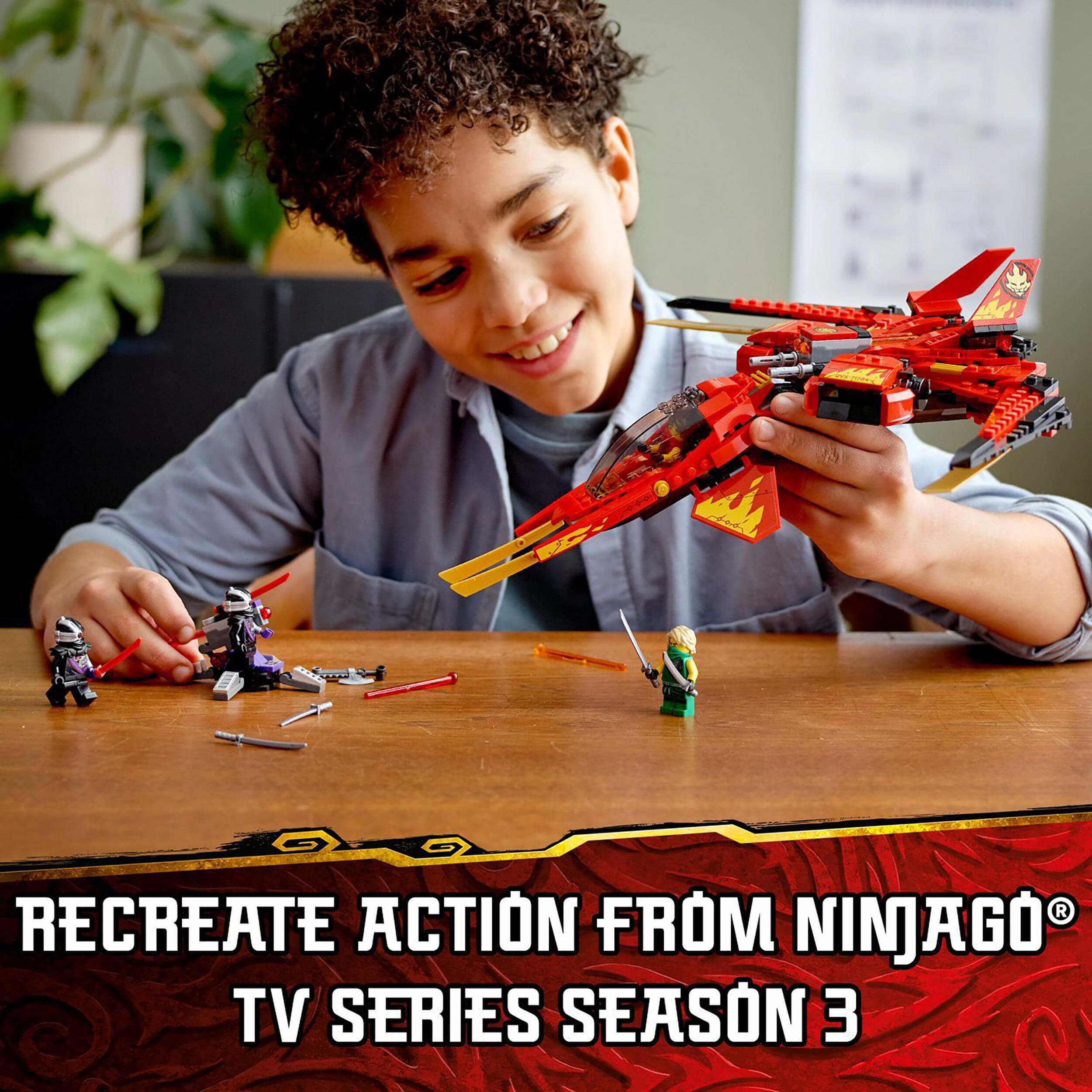 Child playing with LEGO® NINJAGO Legacy Kai Fighter set, recreating scenes from TV Series Season 3.