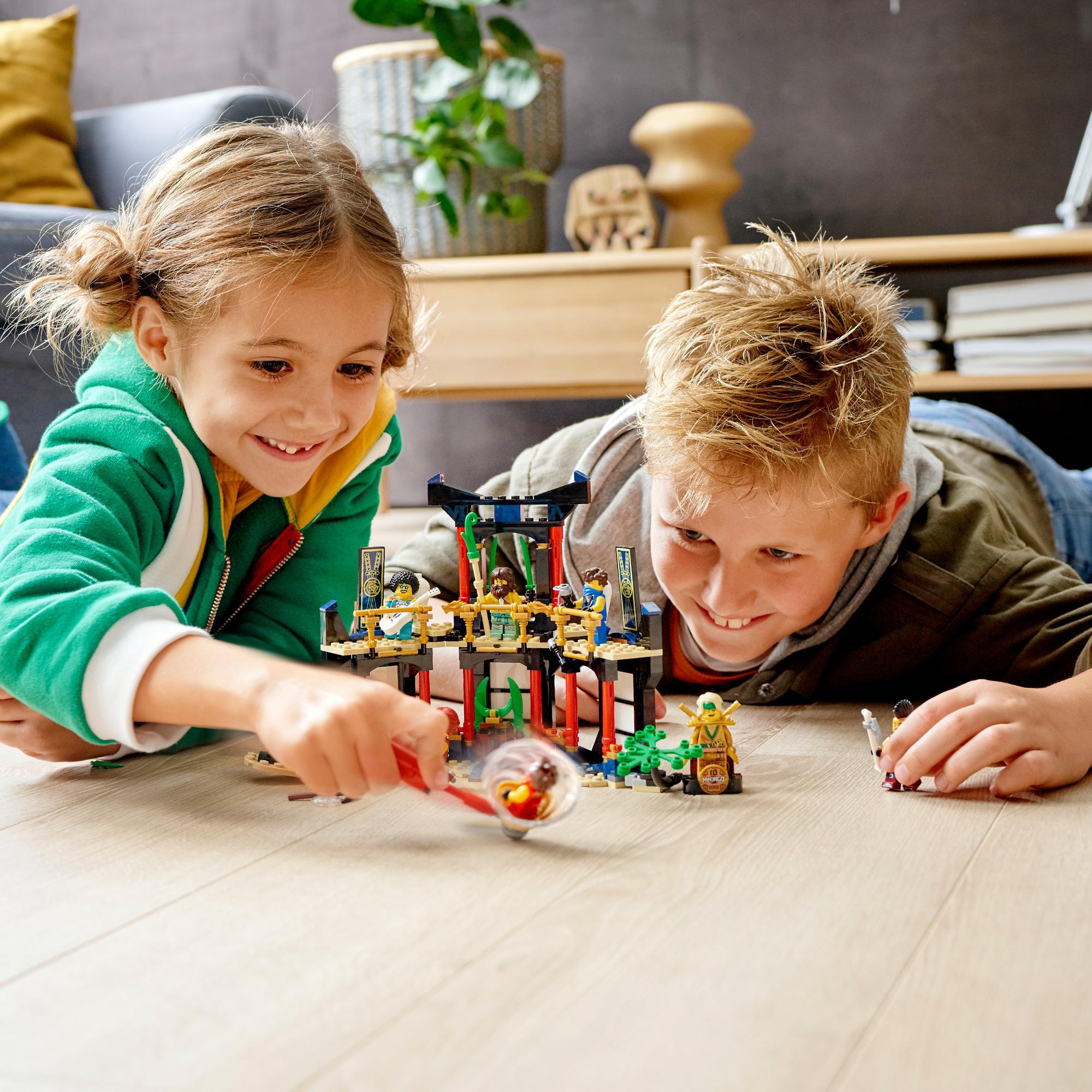 Kids playing with LEGO® NINJAGO Legacy Tournament of Elements Set 71735, showcasing fun and creativity.