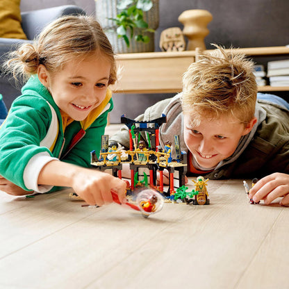 Children enjoying LEGO® NINJAGO Legacy Tournament of Elements Set 71735, roleplaying ninja battles with minifigures.