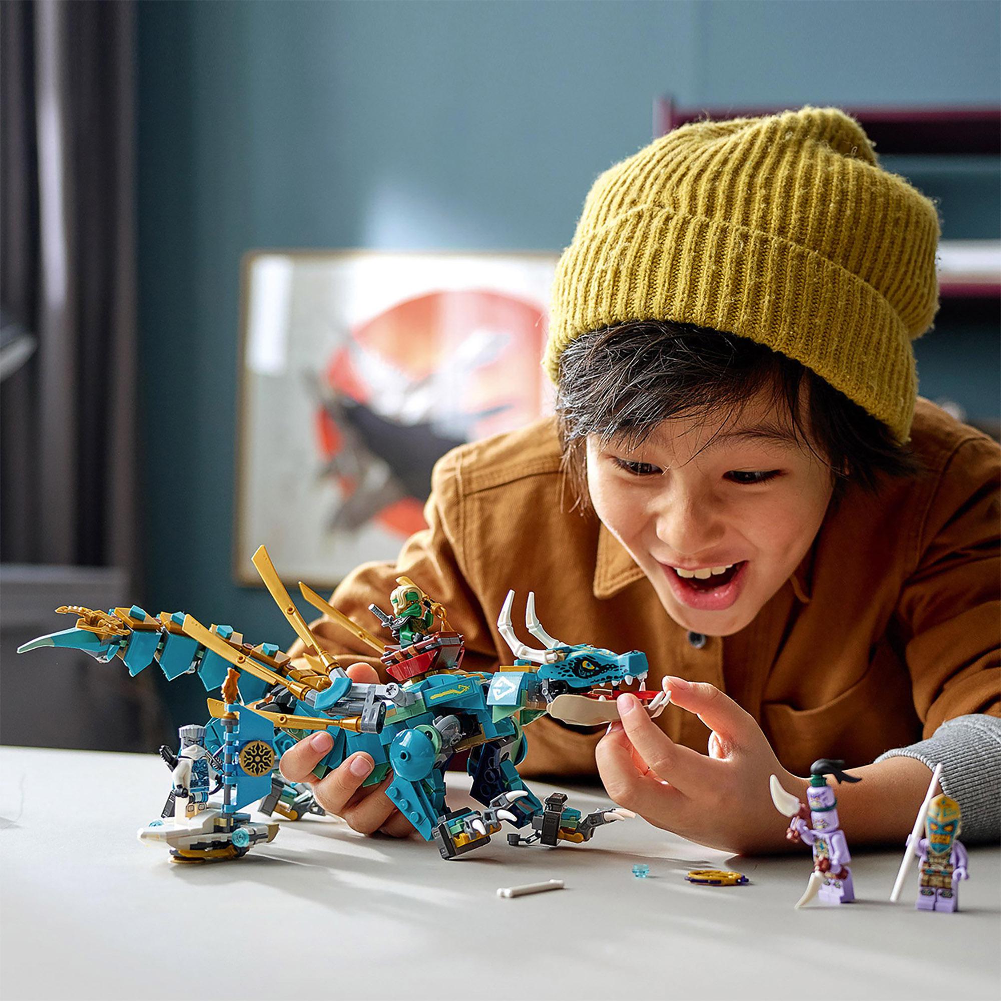 Child playing with LEGO NINJAGO Jungle Dragon set 71746, showcasing creativity and adventure with minifigures.
