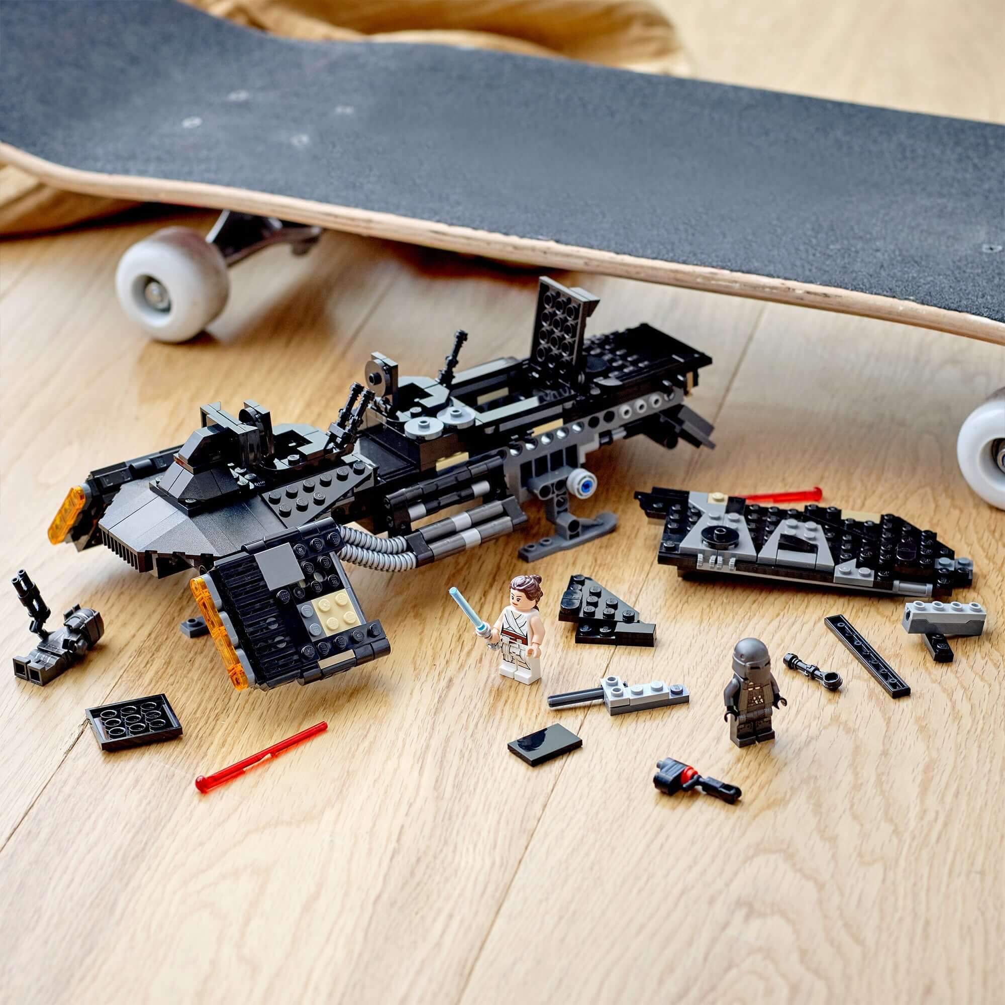 LEGO Star Wars Knights of Ren Transport Ship set with figures and accessories on a wooden floor beside a skateboard.
