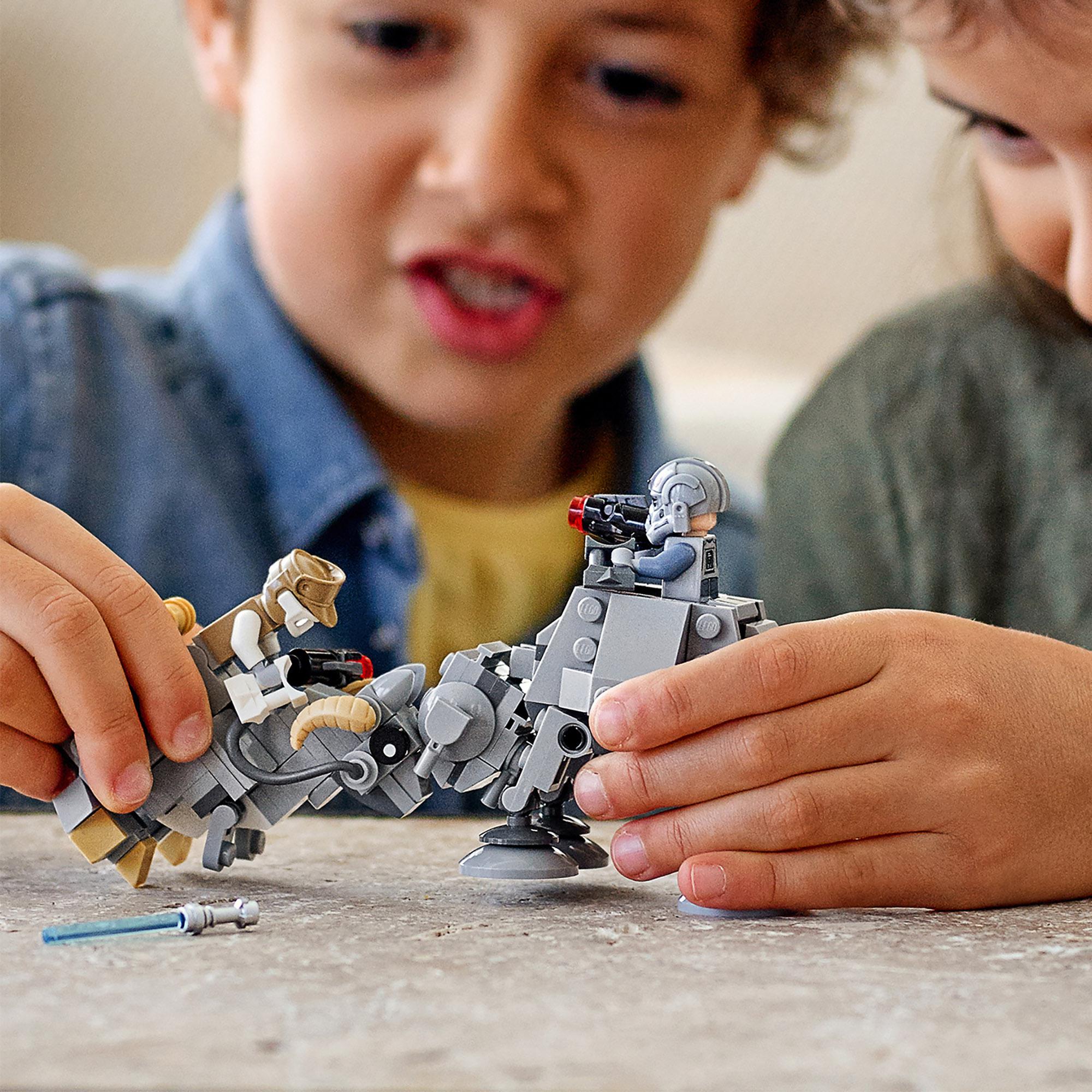 Kids playing with LEGO Star Wars AT-AT and Tauntaun Microfighters set, featuring minifigures and creative battle scenes.