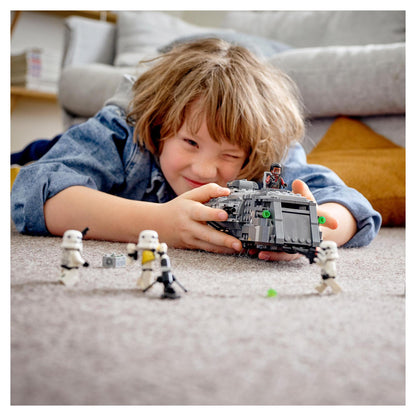 Child playing with LEGO Star Wars Imperial Armoured Marauder Set, reenacting Stormtrooper battles.