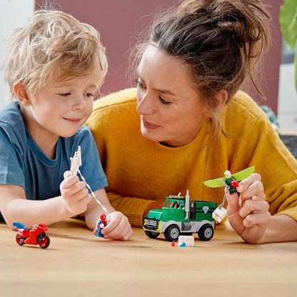 Child and parent playing with LEGO Marvel Spider-Man Trucker Robbery set featuring Spider-Man and Vulture.